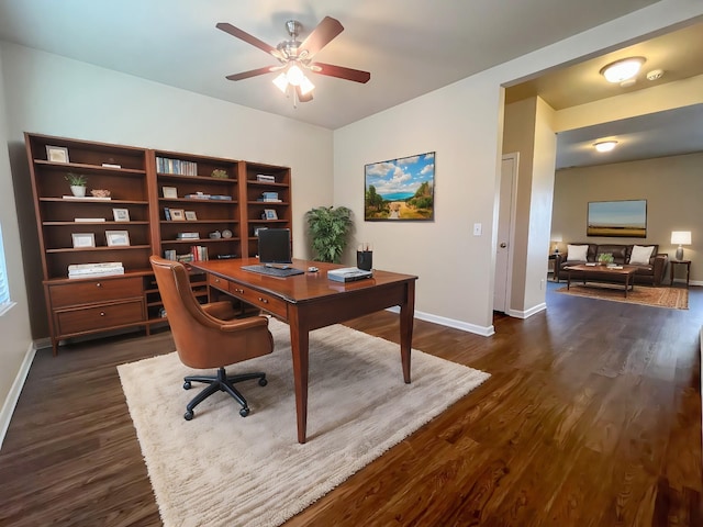 office space with baseboards, a ceiling fan, and dark wood-style flooring