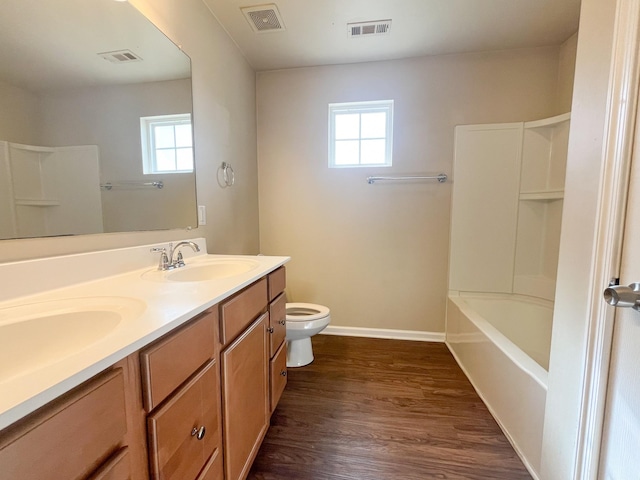 bathroom featuring toilet, visible vents, and a sink