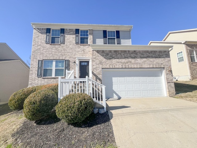 view of front of property featuring brick siding, driveway, and a garage