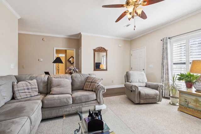 living room featuring ceiling fan, baseboards, visible vents, and ornamental molding