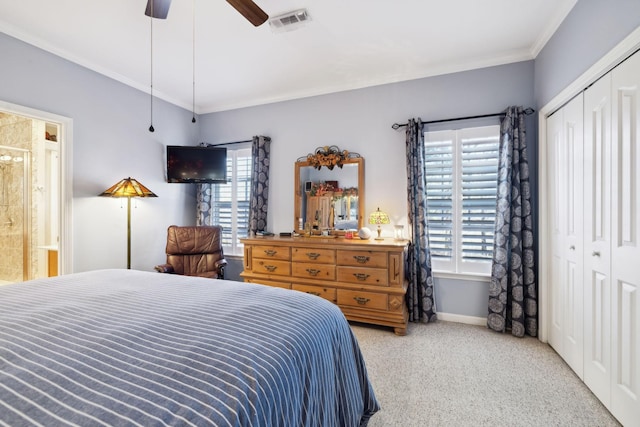 bedroom featuring visible vents, baseboards, ornamental molding, carpet flooring, and a closet