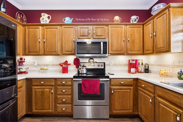 kitchen with light countertops, brown cabinetry, tasteful backsplash, and stainless steel appliances