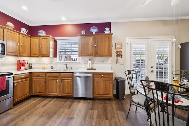 kitchen with a sink, stainless steel appliances, and brown cabinetry