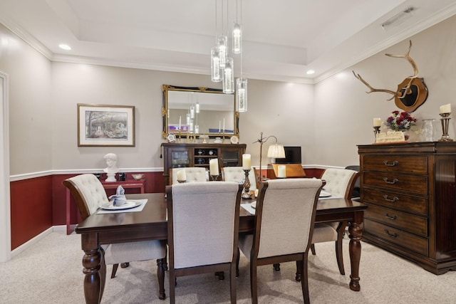 dining space featuring visible vents, recessed lighting, ornamental molding, a raised ceiling, and light colored carpet