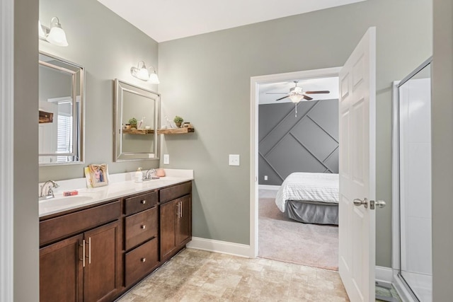 full bath with a sink, baseboards, double vanity, and a ceiling fan