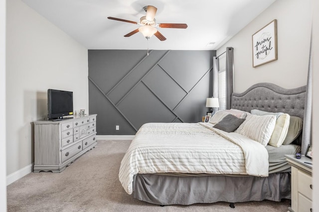 bedroom with light colored carpet, baseboards, and ceiling fan