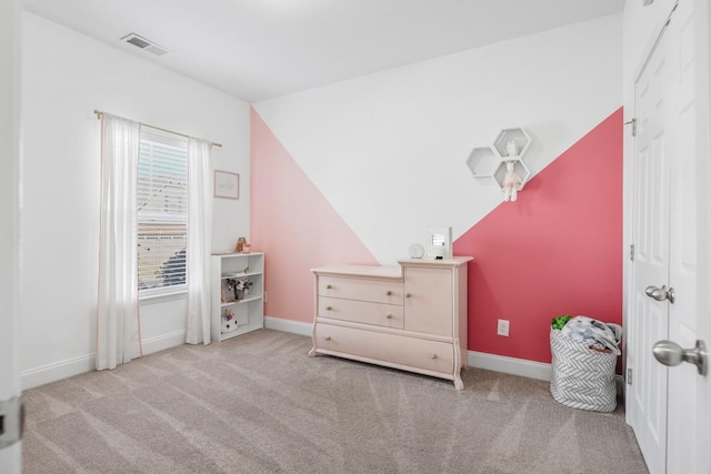 carpeted bedroom with visible vents, baseboards, and lofted ceiling