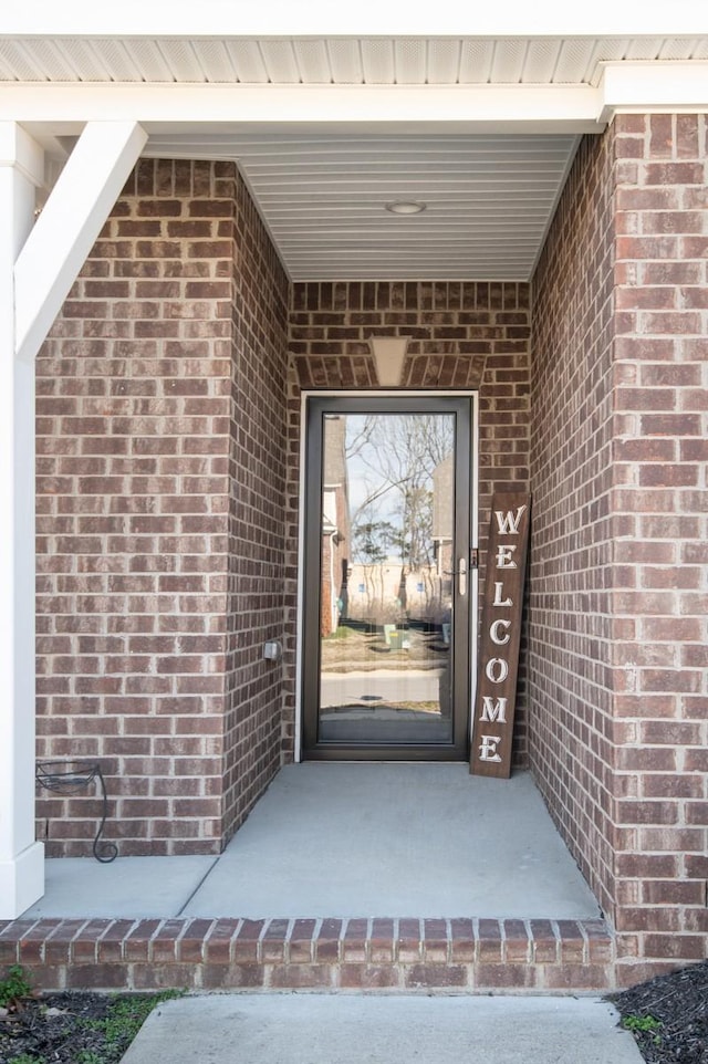 entrance to property with brick siding