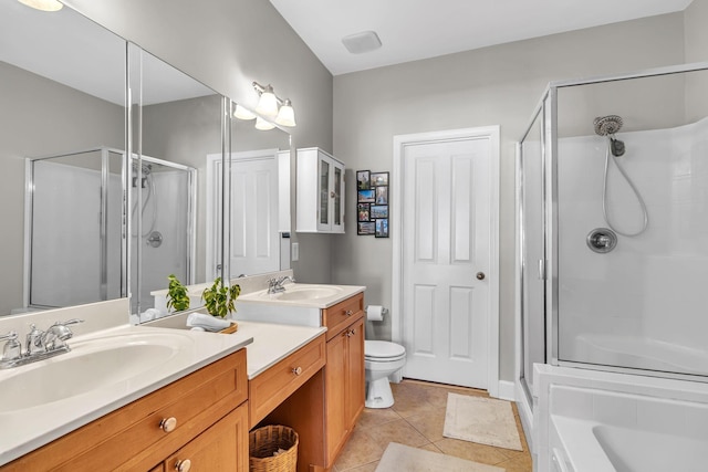 bathroom with tile patterned floors, double vanity, a stall shower, and a sink