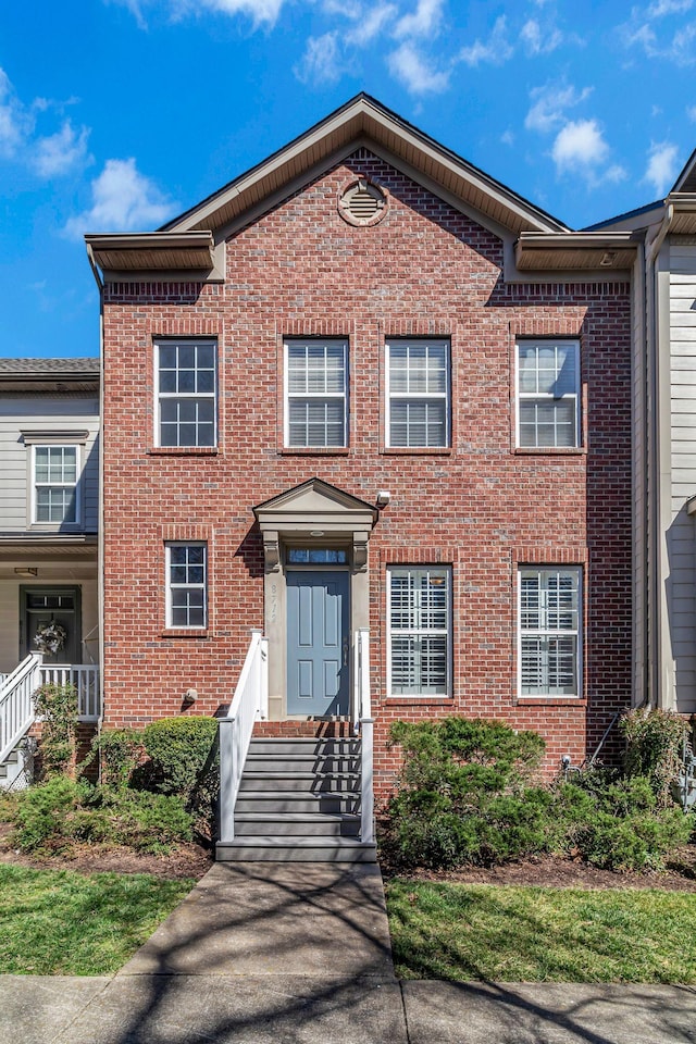 view of front of house featuring brick siding