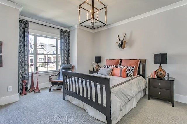 carpeted bedroom featuring baseboards, a chandelier, and crown molding