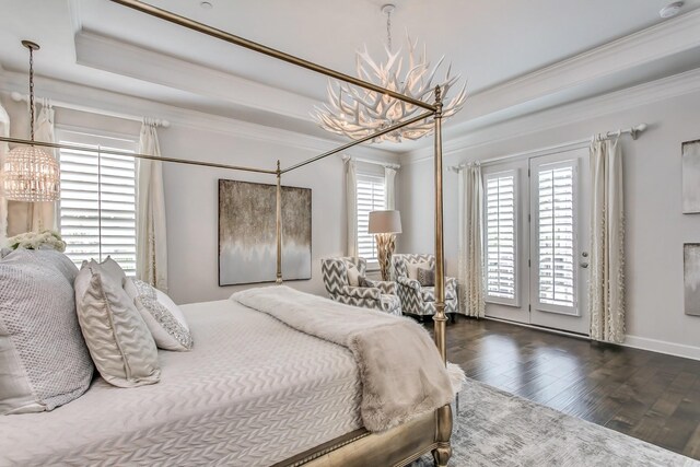 bedroom with an inviting chandelier, access to outside, wood finished floors, and crown molding