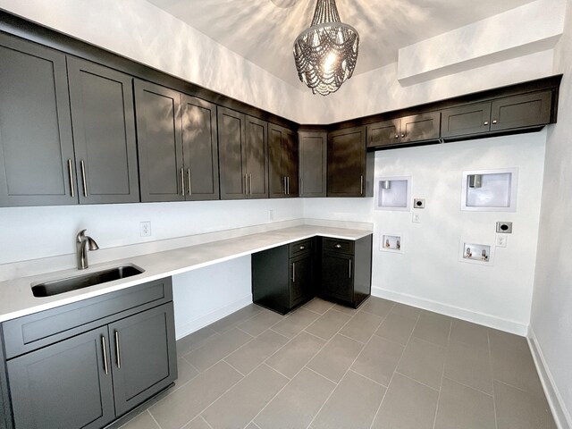 clothes washing area with hookup for a washing machine, baseboards, cabinet space, a sink, and electric dryer hookup