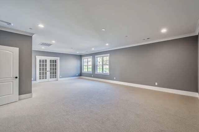 empty room featuring visible vents, french doors, baseboards, and ornamental molding