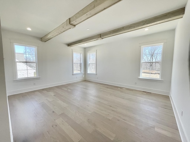 empty room with beamed ceiling, recessed lighting, baseboards, and light wood-type flooring