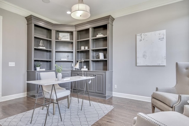 office area featuring ornamental molding, baseboards, and wood finished floors