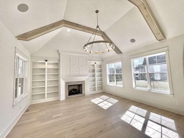 unfurnished living room with a fireplace, lofted ceiling with beams, light wood-style floors, and baseboards