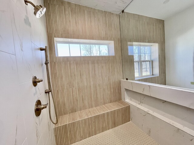 bathroom with a wealth of natural light and tiled shower