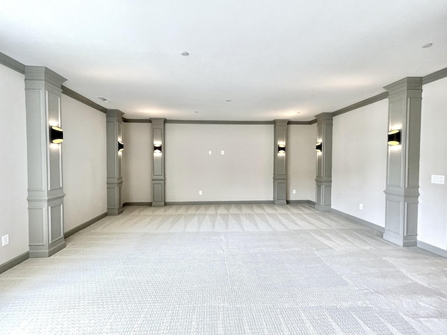 spare room featuring light colored carpet, ornamental molding, and ornate columns