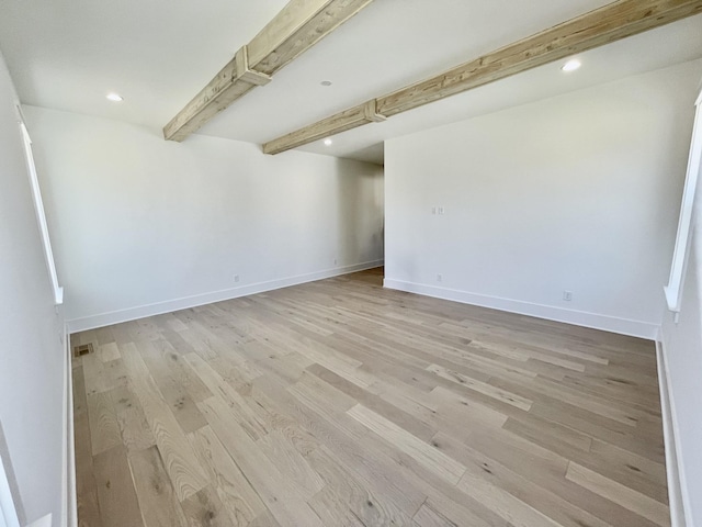 spare room featuring recessed lighting, baseboards, beam ceiling, and light wood-style floors