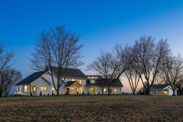 view of front of property featuring stone siding and a front yard