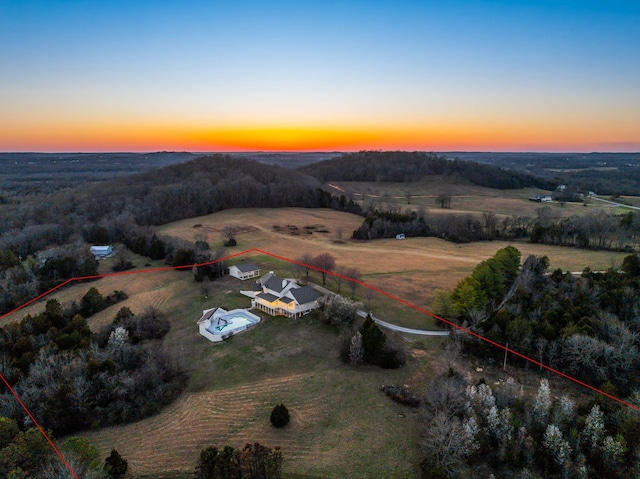 aerial view at dusk featuring a rural view