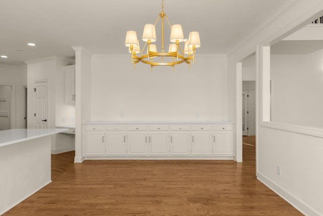 unfurnished dining area with recessed lighting, a chandelier, light wood-style flooring, and crown molding