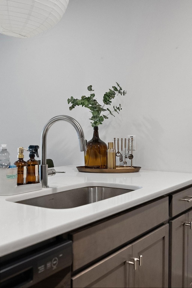 details with dishwasher, light countertops, gray cabinetry, and a sink