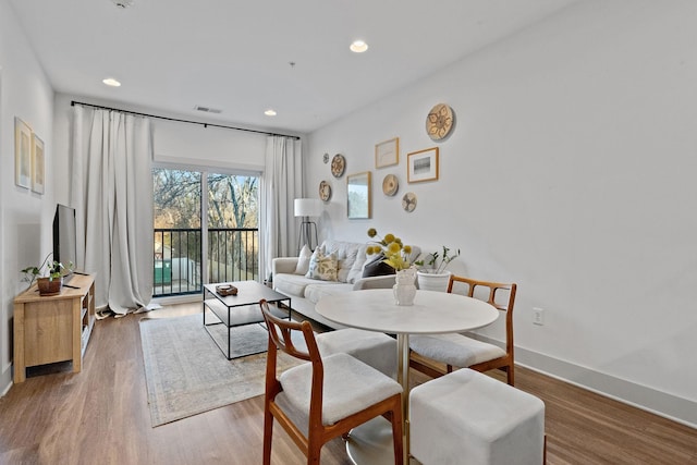 dining room featuring recessed lighting, wood finished floors, visible vents, and baseboards