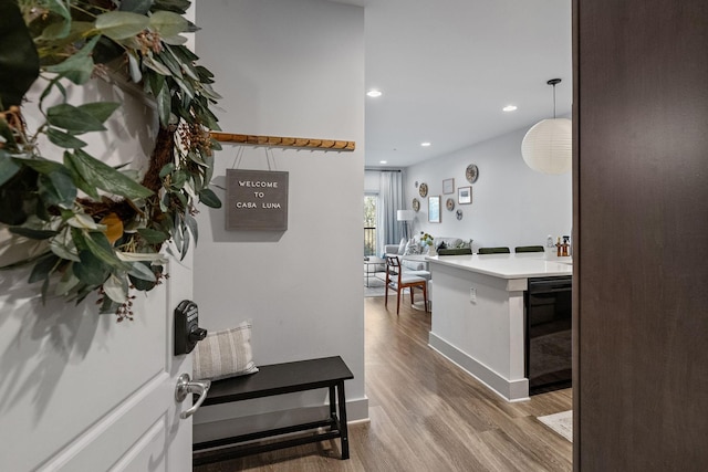 hallway featuring recessed lighting, baseboards, and wood finished floors