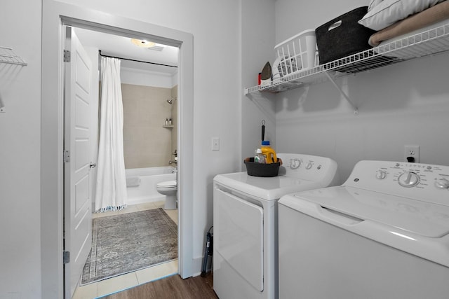 washroom featuring washer and clothes dryer, laundry area, and dark wood finished floors