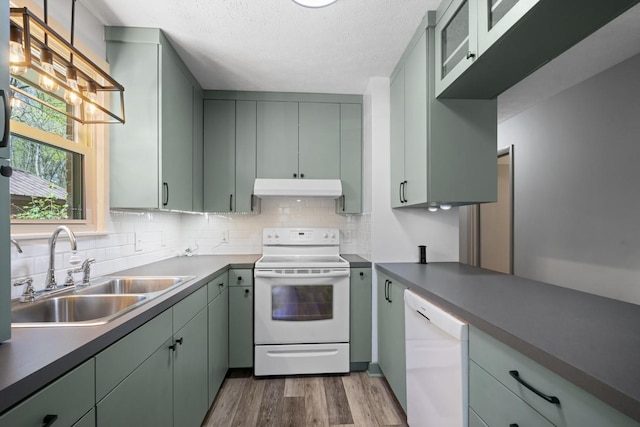 7704 Chester Rd, Fairview, TN 37062 - kitchen with white appliances, under cabinet range hood, wood finished floors, backsplash, and a textured ceiling