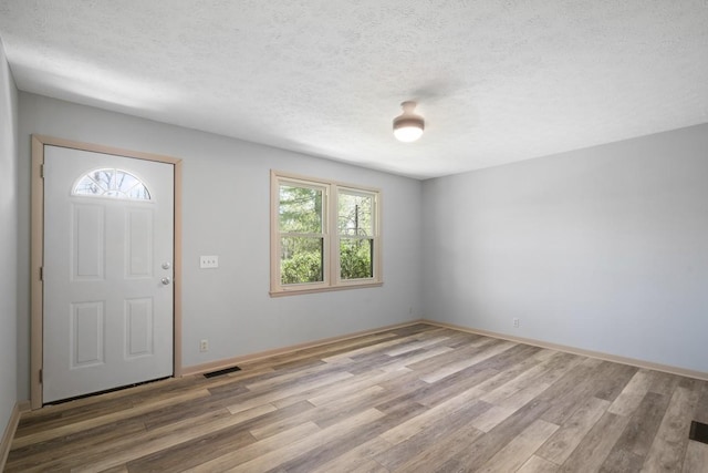7704 Chester Rd, Fairview, TN 37062 - entrance foyer with wood finished floors, plenty of natural light, and a textured ceiling