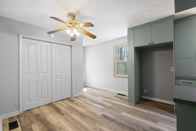 7704 Chester Rd, Fairview, TN 37062 - unfurnished bedroom with light wood finished floors, a textured ceiling, a ceiling fan, and a closet