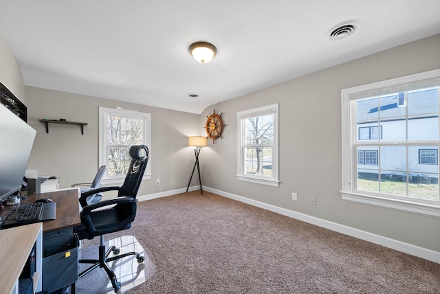 carpeted office space with visible vents and baseboards