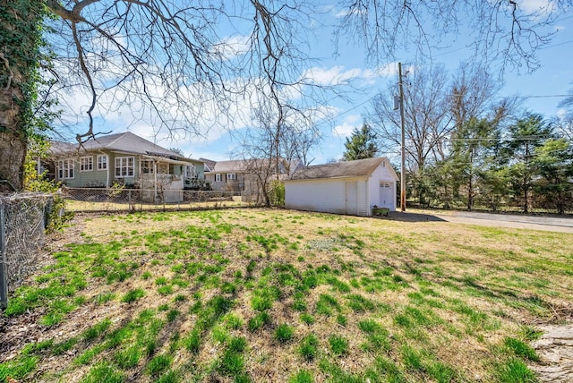 view of yard with an outdoor structure and fence