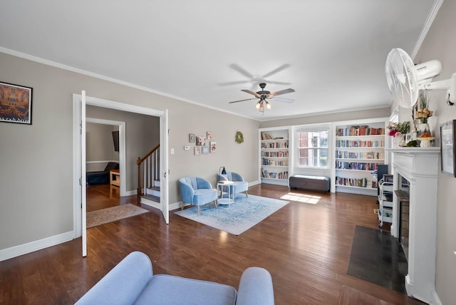 living room featuring a fireplace with flush hearth, wood finished floors, stairway, crown molding, and baseboards