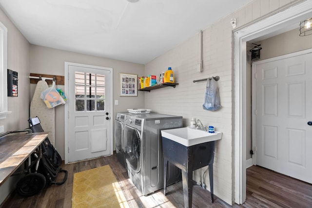 laundry room with laundry area, washing machine and dryer, and dark wood-style flooring