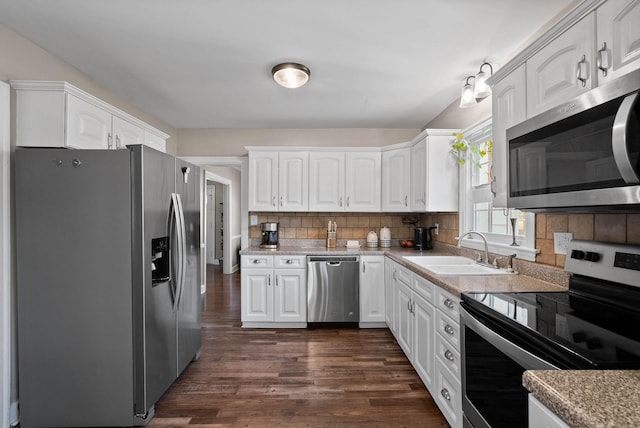 kitchen with white cabinetry, tasteful backsplash, appliances with stainless steel finishes, and a sink