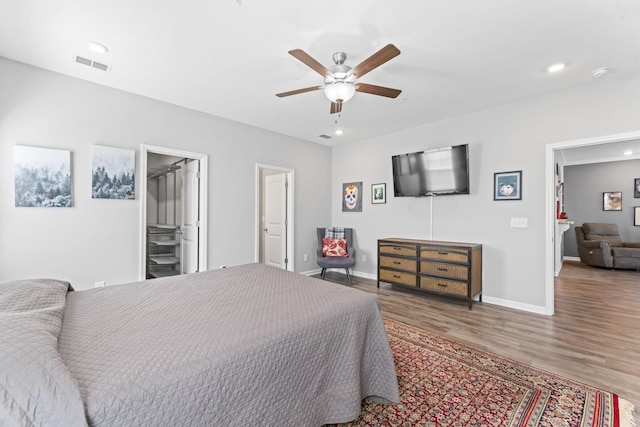 bedroom featuring recessed lighting, wood finished floors, visible vents, and baseboards