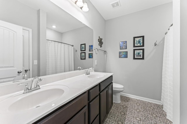 full bath with visible vents, toilet, baseboards, and a sink