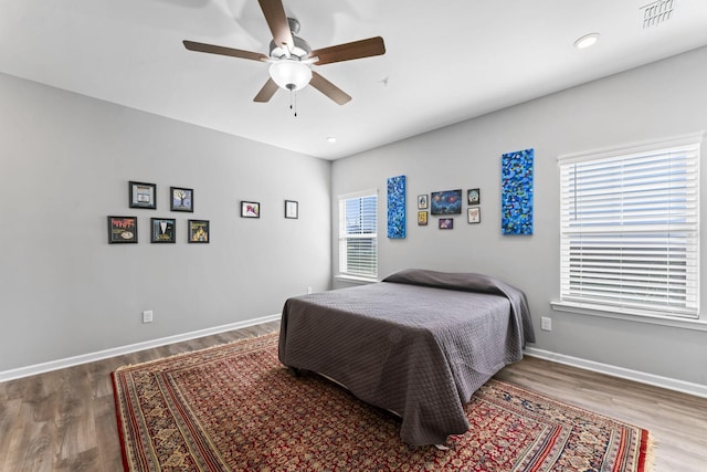 bedroom with visible vents, a ceiling fan, wood finished floors, recessed lighting, and baseboards