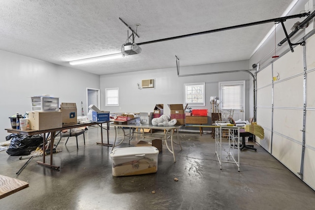 garage featuring a garage door opener and a wall mounted AC