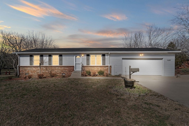 ranch-style house featuring a yard, concrete driveway, a garage, crawl space, and brick siding