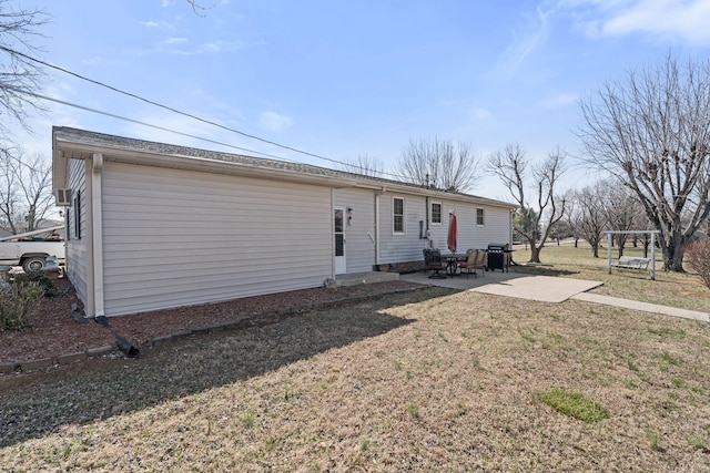 view of front of home featuring entry steps, a front yard, and a patio