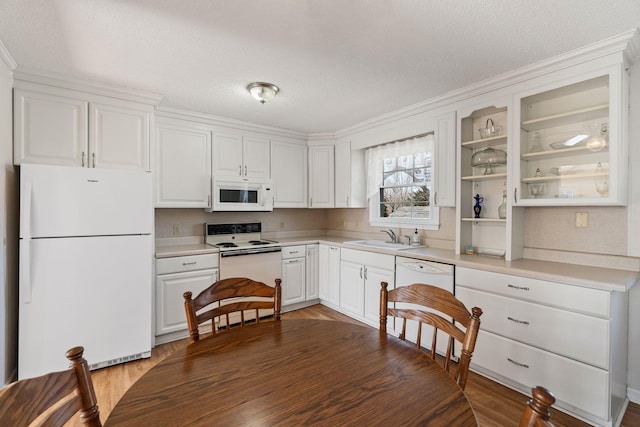 kitchen featuring a sink, open shelves, white cabinetry, white appliances, and light countertops