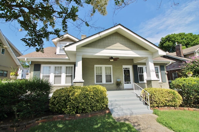 view of front of house featuring brick siding, a porch, and a ceiling fan