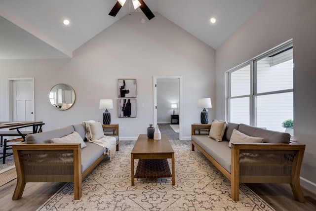 living area with light wood finished floors, ceiling fan, baseboards, recessed lighting, and high vaulted ceiling