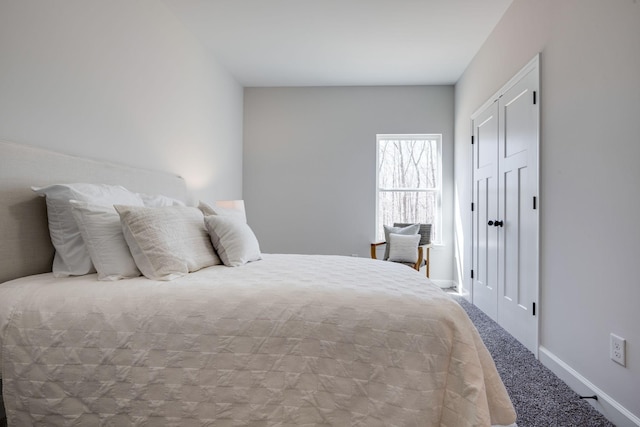 bedroom with baseboards and carpet floors