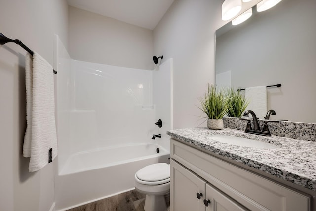 full bathroom with shower / washtub combination, toilet, vanity, and wood finished floors